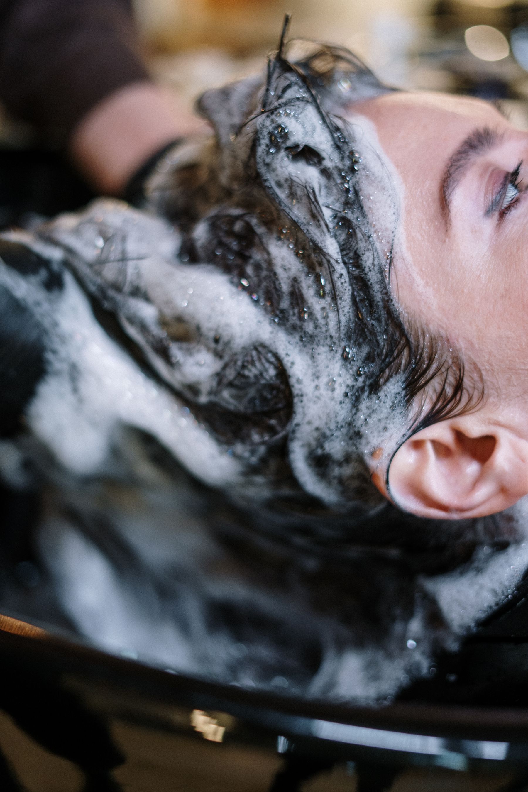 Client having her hair washed with foam